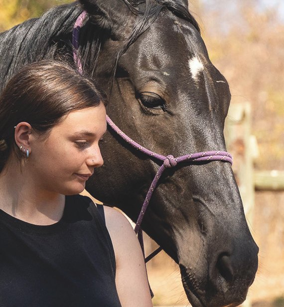 In Africa, a girl and a horse stand close, embodying a profound connection. Amidst a volunteer-run sanctuary for healing, their bond transcends words, offering solace and strength to all who witness it.